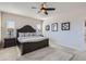 Primary bedroom featuring a dark wood bed frame, neutral decor, and plenty of natural light at 10723 Sedalia St, Commerce City, CO 80022