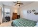 Comfortable bedroom with a desk, chair, dresser, ceiling fan, closet, and decor on the walls at 10723 Sedalia St, Commerce City, CO 80022