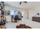 Inviting bonus room with ample space, including a desk, chair, hide rug, and decor at 10723 Sedalia St, Commerce City, CO 80022