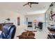 Spacious bonus room featuring two cozy chairs, a hide rug, decor, and ceiling fan at 10723 Sedalia St, Commerce City, CO 80022