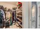 Walk-in closet with built in shelving and racks to maximize storage, with an ensuite bathroom at 10723 Sedalia St, Commerce City, CO 80022