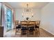 Dining area featuring a large wooden table, seating for eight, modern lighting, and a sliding glass door at 10723 Sedalia St, Commerce City, CO 80022