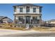 Charming two-story home featuring a welcoming front porch and neutral color palette at 10723 Sedalia St, Commerce City, CO 80022