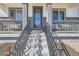 Inviting covered front porch with decorative columns and a well-lit entrance at 10723 Sedalia St, Commerce City, CO 80022