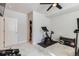 Home gym features an exercise bike, weight bench, and bright light from a window at 10723 Sedalia St, Commerce City, CO 80022