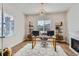Bright home office with a chandelier, desk, and ample natural light, creating an inspiring workspace at 10723 Sedalia St, Commerce City, CO 80022