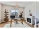 Elegant home office featuring a fireplace, bookshelves, and modern desk setup at 10723 Sedalia St, Commerce City, CO 80022