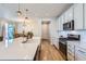 Well-lit kitchen featuring stone countertops, stainless steel appliances, and an open design at 10723 Sedalia St, Commerce City, CO 80022
