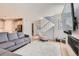 Open-concept living area with a fireplace, staircase, and seamless flow to the kitchen at 10723 Sedalia St, Commerce City, CO 80022