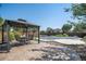 Backyard features a patio with gazebo and a swimming pool with pool cover at 13087 Krameria St, Thornton, CO 80602