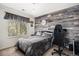 Cozy bedroom with decorative wall, desk, and window with natural light at 13087 Krameria St, Thornton, CO 80602