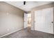 Bedroom featuring neutral walls and carpet, plus a double-door closet and entry door at 13087 Krameria St, Thornton, CO 80602