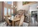 Bright dining area showcases a dining table and adjacent living room with large windows at 13087 Krameria St, Thornton, CO 80602