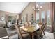Open-concept dining room showcasing natural light and adjacent living room at 13087 Krameria St, Thornton, CO 80602