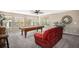 Upstairs bonus room with a pool table, comfortable red sofa and natural light at 13087 Krameria St, Thornton, CO 80602