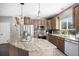 Spacious kitchen with island, stainless steel appliances and wooden cabinets at 13087 Krameria St, Thornton, CO 80602