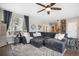 Inviting living room featuring a sectional couch, hardwood floors, and staircase at 13087 Krameria St, Thornton, CO 80602