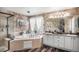 Beautiful main bathroom featuring a soaking tub, double vanity, and wood-look flooring at 13087 Krameria St, Thornton, CO 80602