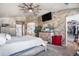 Spacious main bedroom featuring a ceiling fan, TV, and access to a large walk-in closet at 13087 Krameria St, Thornton, CO 80602