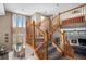 Staircase features a wooden banister and views into the adjacent dining and living areas at 13087 Krameria St, Thornton, CO 80602