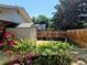 Backyard with a storage shed, a wooden fence, and flowering bushes creating a private outdoor space at 984 S Braun Dr, Lakewood, CO 80228