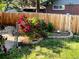 The backyard garden is decorated with a flower bed and a wooden fence for privacy at 984 S Braun Dr, Lakewood, CO 80228