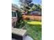 The backyard features a cozy sitting area, climbing roses, and well-maintained landscaping at 984 S Braun Dr, Lakewood, CO 80228