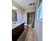 Neutral bathroom with a granite vanity, shower with glass door, and a window for natural light at 984 S Braun Dr, Lakewood, CO 80228