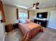 Bedroom with a ceiling fan, natural light from a large window, and wood furniture at 984 S Braun Dr, Lakewood, CO 80228
