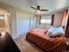 Bedroom with a ceiling fan, large closet with sliding doors, and a window for natural light at 984 S Braun Dr, Lakewood, CO 80228