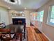 Open dining room with hardwood floors, modern fixtures, and a dutch door leading to an adjacent space at 984 S Braun Dr, Lakewood, CO 80228