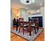 Inviting dining room featuring a dark wood table set on a colorful area rug and a modern light fixture at 984 S Braun Dr, Lakewood, CO 80228