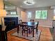 Bright dining room featuring hardwood floors, a cozy fireplace and a view to the home's exterior at 984 S Braun Dr, Lakewood, CO 80228