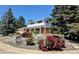 Charming two-story home with brick accents, colorful landscaping, and a well-maintained front yard at 984 S Braun Dr, Lakewood, CO 80228