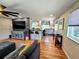 Open-concept living space featuring hardwood floors, modern decor, and a seamless flow into the kitchen at 984 S Braun Dr, Lakewood, CO 80228