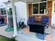 Cozy patio with outdoor seating, a colorful rug, and a gas fire pit for relaxing evenings at 984 S Braun Dr, Lakewood, CO 80228