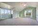 Bright bedroom featuring vaulted ceilings, two windows with bright light, and neutral carpet at 18394 Heavens Pl, Monument, CO 80132