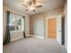 Comfortable bedroom with a large window, neutral carpet, a ceiling fan, and a closet at 18394 Heavens Pl, Monument, CO 80132