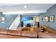 Finished basement with a large screen and comfortable seating area at 9767 Burberry Way, Highlands Ranch, CO 80129