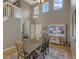 Bright dining area with soaring ceilings, hardwood floors, and plenty of natural light from large windows at 9767 Burberry Way, Highlands Ranch, CO 80129