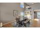 Open dining room with high ceilings, hardwood floors, and a large window providing natural light at 9767 Burberry Way, Highlands Ranch, CO 80129