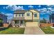 Charming two-story home with a well-manicured lawn, covered front porch, and attached two-car garage at 9767 Burberry Way, Highlands Ranch, CO 80129