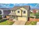 Two-story home featuring a manicured lawn, covered front porch, attached two-car garage and mountain views at 9767 Burberry Way, Highlands Ranch, CO 80129