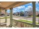 Inviting front porch with charming railing and columns, perfect for enjoying the neighborhood view at 9767 Burberry Way, Highlands Ranch, CO 80129
