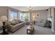 Bright living room featuring large windows and comfortable seating near the fireplace at 9767 Burberry Way, Highlands Ranch, CO 80129