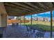 Spacious covered patio with comfortable seating and landscaped backyard at 9767 Burberry Way, Highlands Ranch, CO 80129