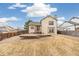 View of backyard showcasing a wooden deck, spacious yard and surrounding homes at 10663 Dexter Dr, Thornton, CO 80233