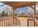 View of backyard from covered patio, featuring trees and homes in the distance at 10663 Dexter Dr, Thornton, CO 80233