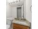 Bathroom with wooden cabinets and granite countertop at 10663 Dexter Dr, Thornton, CO 80233