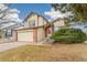 Charming two-story home with brick accents, a well-maintained front yard, and a cozy bench near the entrance at 10663 Dexter Dr, Thornton, CO 80233